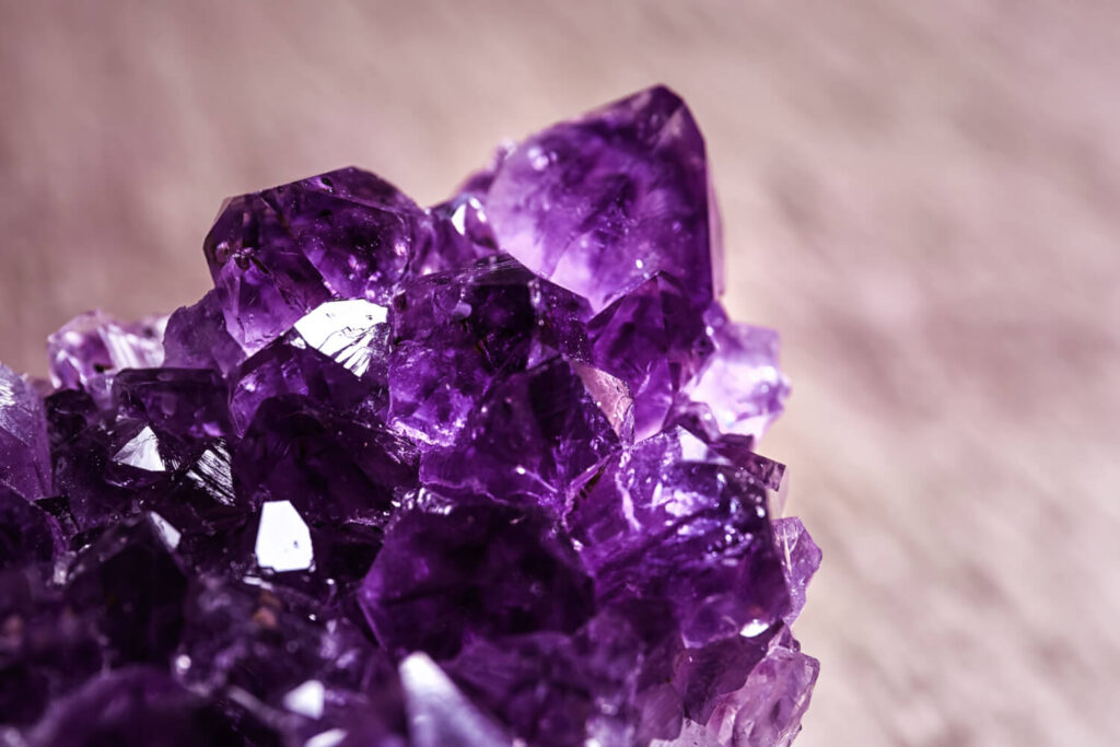 Close-up amethyst cluster, deep purple crystals.