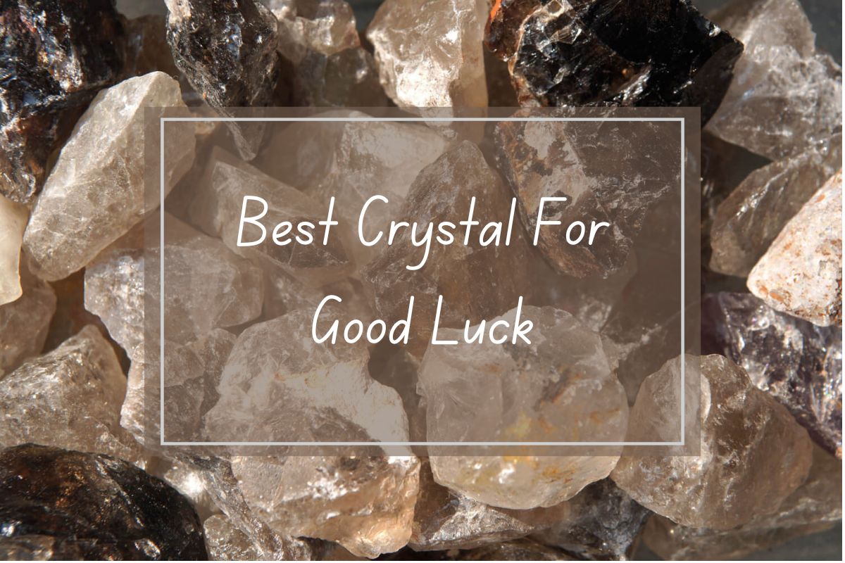 Close-up of various tumbled crystals, including clear quartz, smoky quartz, and others.  Text overlay reads "Best Crystal For Good Luck".