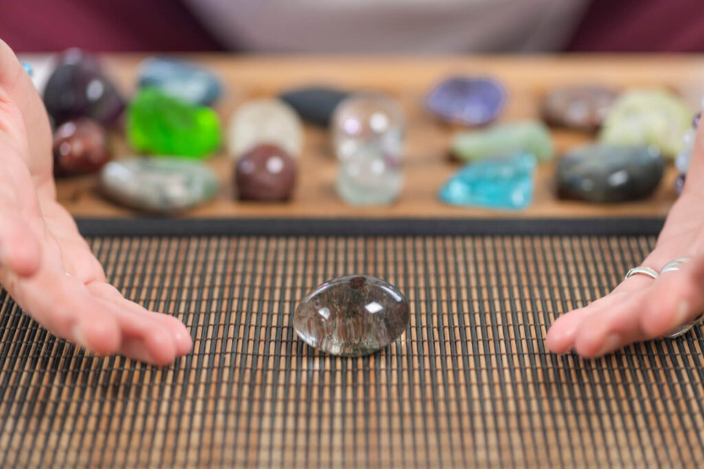 Clear quartz crystal, gemstone, on bamboo placemat.