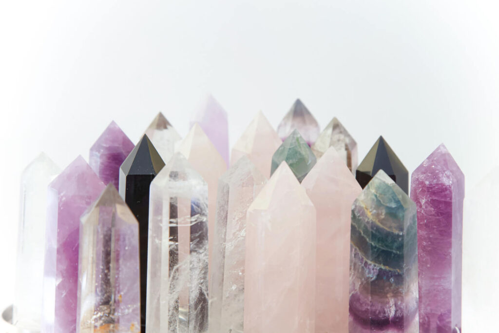 Assorted colored gemstone points.  Purple, pink, clear, black crystals.