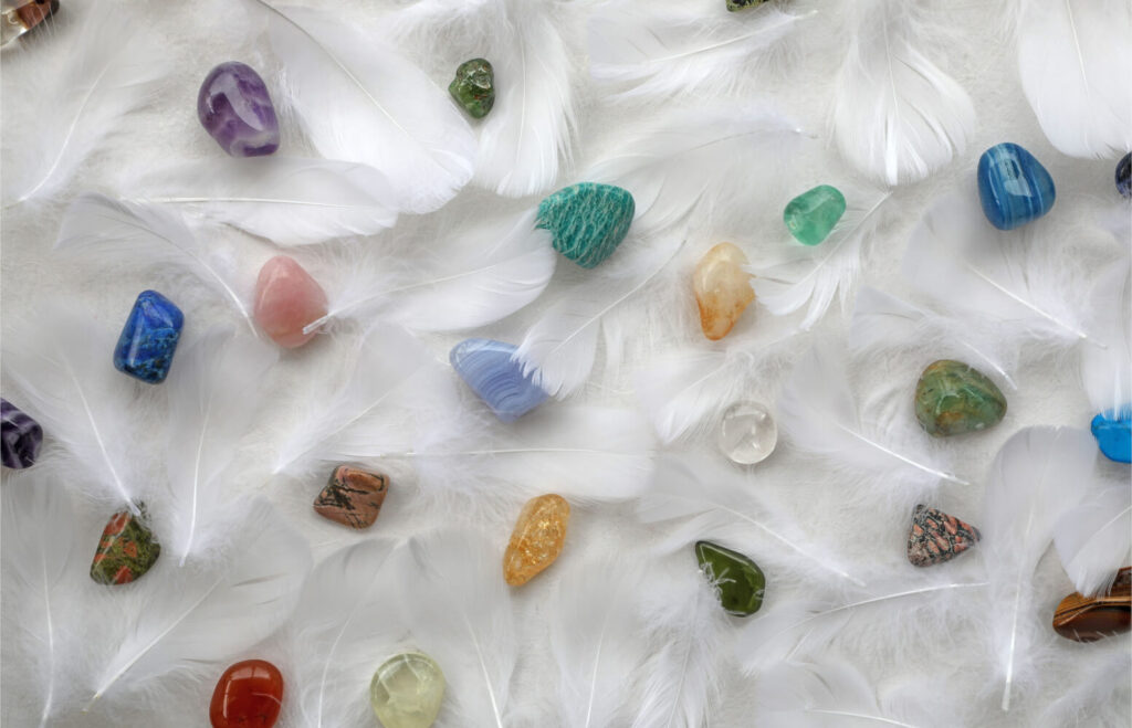 Colorful gemstones and white feathers.