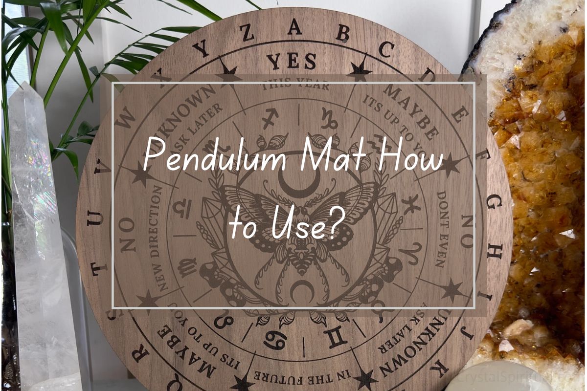 Wooden pendulum mat with various symbols, zodiac signs, and text like "Yes," "Maybe," "Unknown," and "Ask Later."  How-to guide.