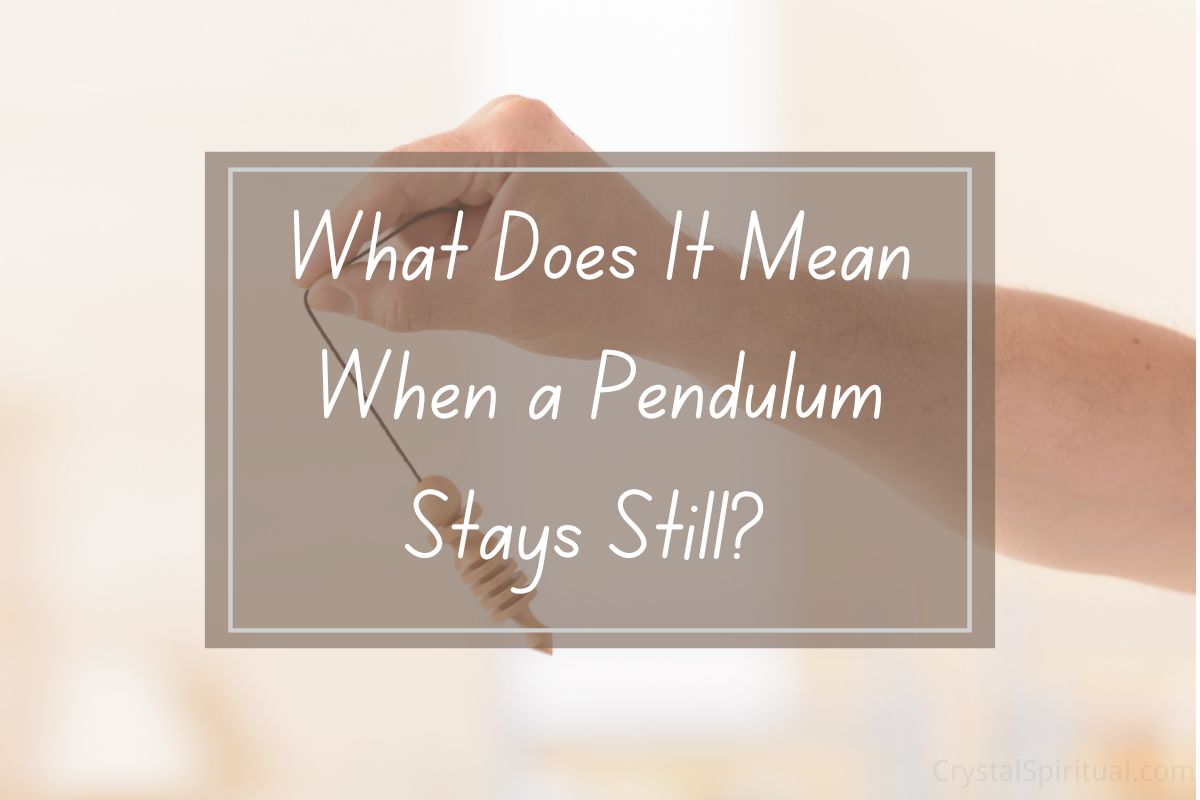 Hand holding pendulum, question: "What does it mean when a pendulum stays still?".