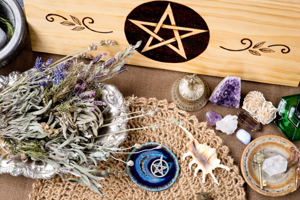 Dried herbs, crystals, and a pentagram on a wooden board. Witchcraft altar.