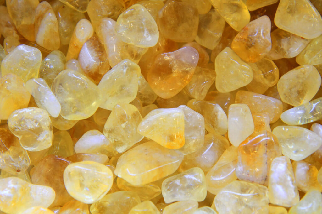 Small, tumbled, yellow crystals.