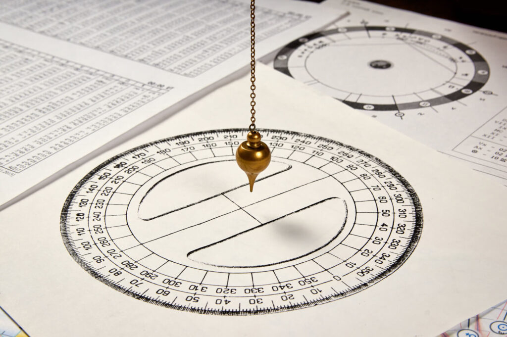 Protractor, pendulum, and papers. Engineering or similar precision tools.