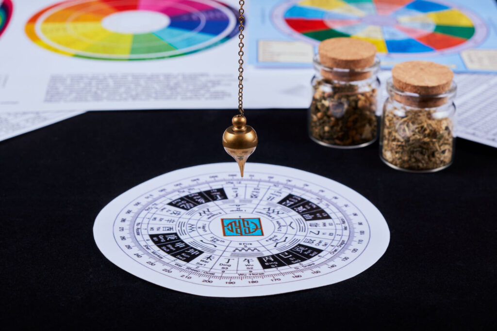 Feng Shui compass, pendulum, and herbs.  Divination tools.