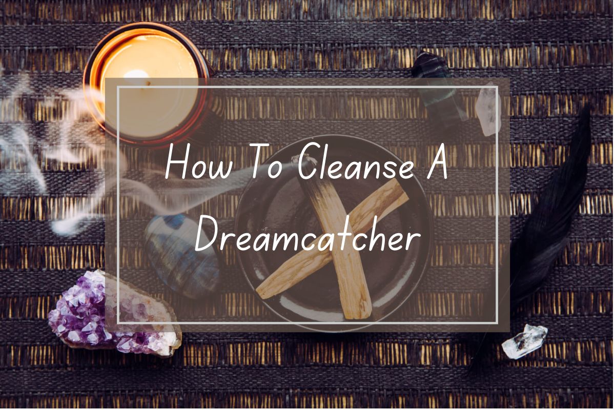 Smudging a dreamcatcher with sage.  Spiritual cleansing. Crystals, candle, and feather.