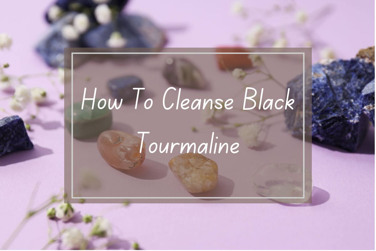 How to cleanse black tourmaline; various colored gemstones and crystals on a pastel purple surface.