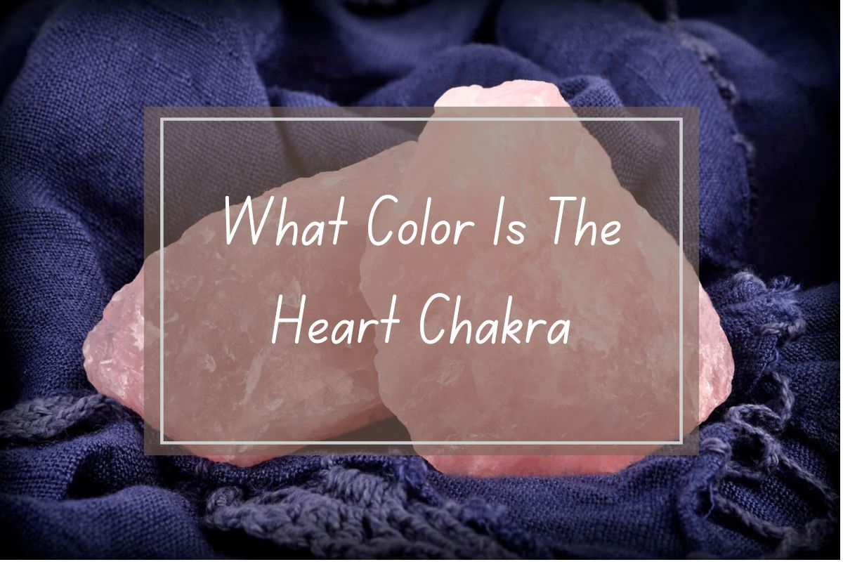 Pink rose quartz crystals on dark blue fabric, text overlay: "What Color Is The Heart Chakra?"