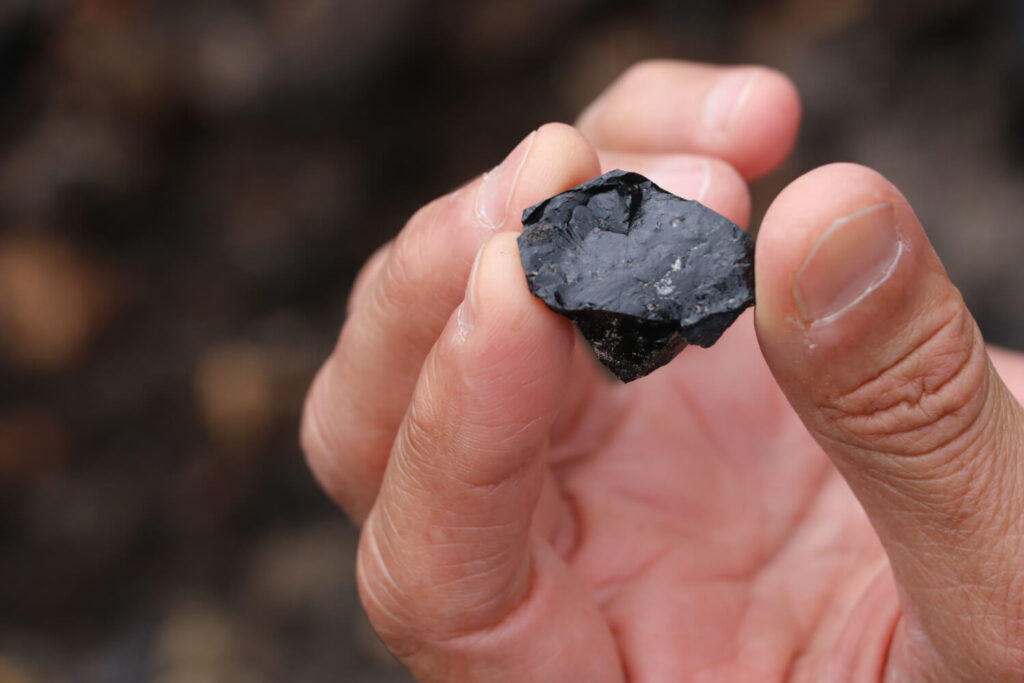 Black rock held in hand.