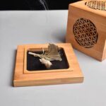 Wooden incense burner tray with burning sage, flower of life design.