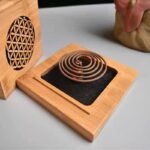 Wooden incense burner with spiral incense holder.
