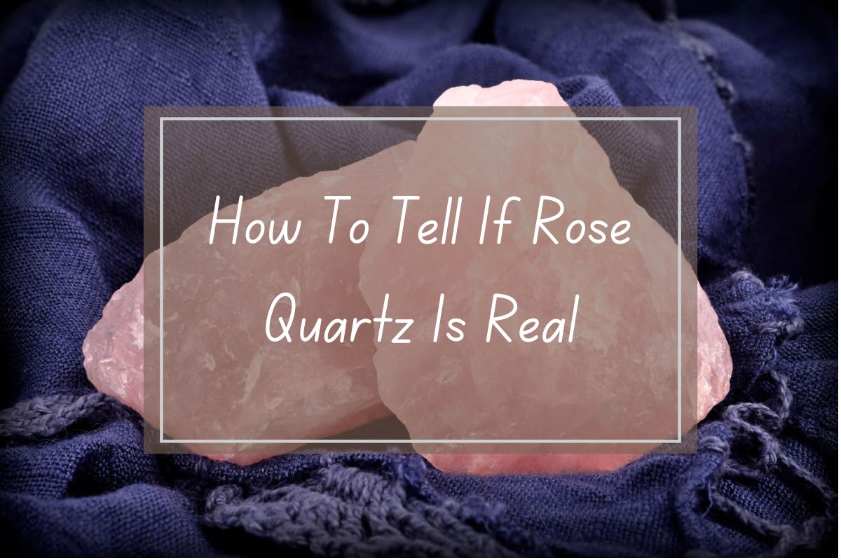 Pink rose quartz crystals on dark fabric.  How to tell if rose quartz is real.